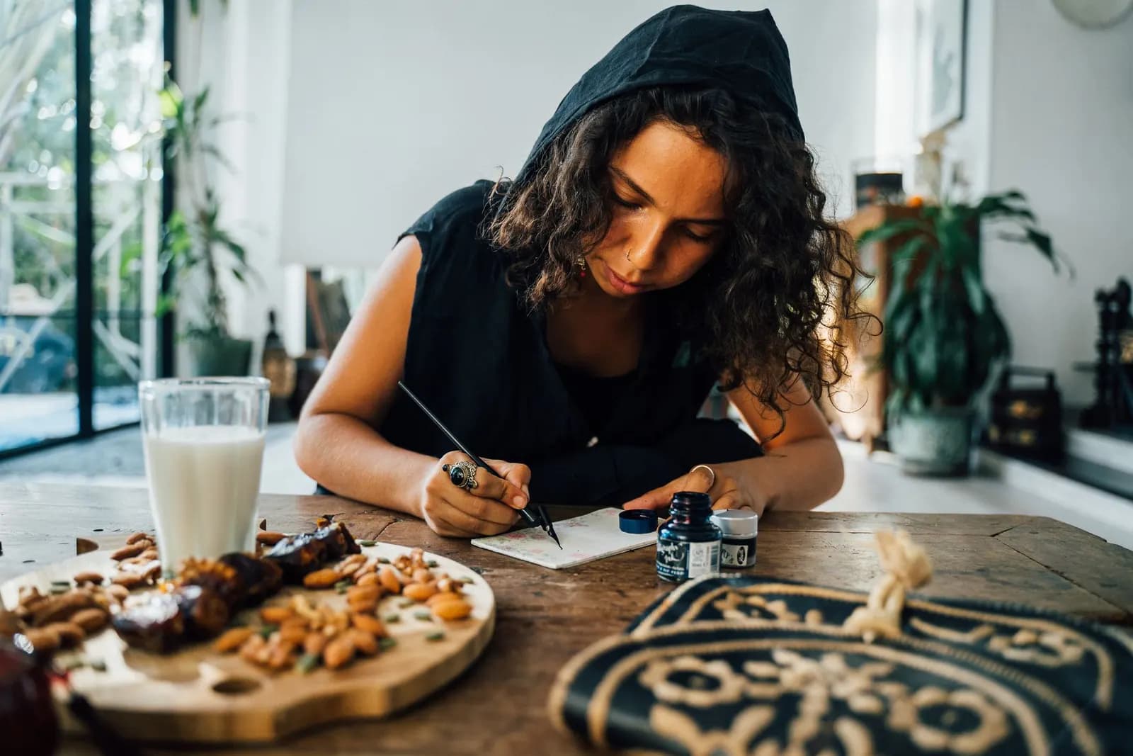 Someone writing a letter at a table