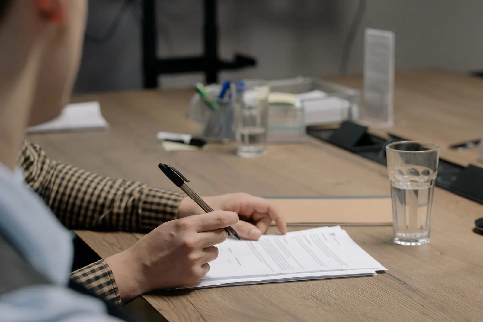 Someone working through documents at a desk