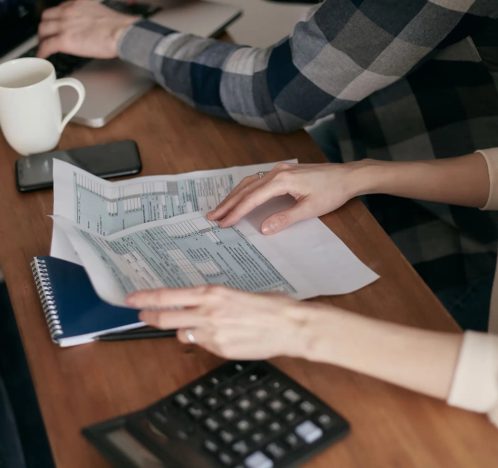 A desk with paperwork in a small office